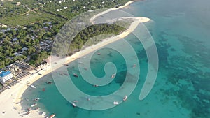 Traditional Africal Sailboats at Zanzibar Kendwa beach at evening time with blue Indian ocean aerial view