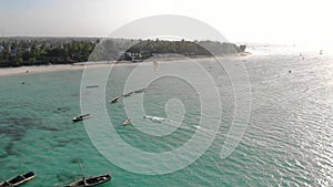 Traditional Africal Sailboats at Zanzibar Kendwa beach at evening time with blue Indian ocean aerial view