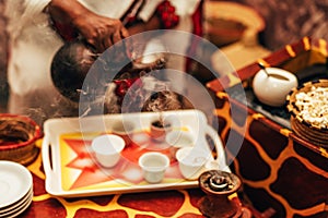 Traditional african barista preparing coffee as in its origin as a steaming hot beverage.