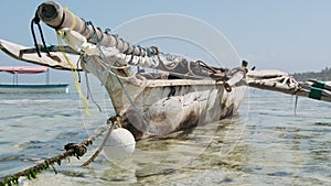 Traditional African Fishing Boat Stranded in Sand on Beach at Low Tide, Zanzibar