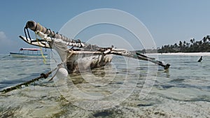 Traditional African Fishing Boat Stranded in Sand on Beach at Low Tide, Zanzibar