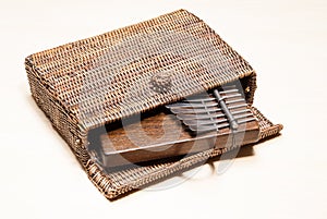 Traditional African instrument kalimba or thumb piano in a wicker case