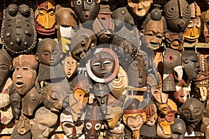 Traditional african masks hanging for sell in a market stall