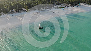 Traditional African Sailboat at Zanzibar island Paje beach in blue Indian ocean aerial view. Unguja, tanzania