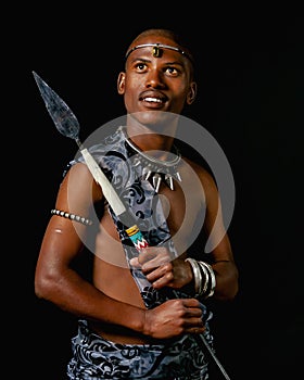 Traditional African Xhosa prince holding a traditional beaded handmade spear. photo