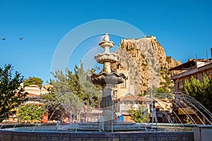 Traditional Afyonkarahisar houses, ornamental pool and Afyon Castle in Afyonkarahisar Turkey