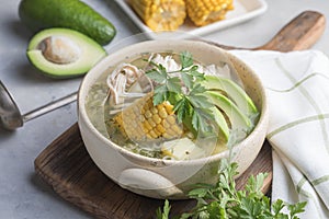 Traditional Ajiaco Colombiano - Colombian Soup with potato, chicken, avocado