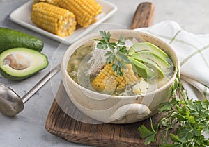 Traditional Ajiaco Colombiano - Colombian Soup with potato, chicken, avocado photo