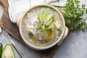 Traditional Ajiaco Colombiano - Colombian Soup with potato, chicken, avocado photo