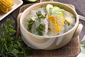 Traditional Ajiaco Colombiano - Colombian Soup with potato, chicken, avocado photo