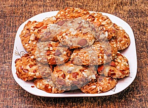 traditional almond cookies ameretti biscuits in dish isolated on dark wooden background top view