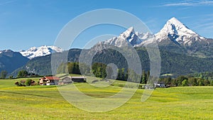 Traditional Alpine spring panoramic landscape in Berchtesgaden with Watzmann mount and flowering meadow
