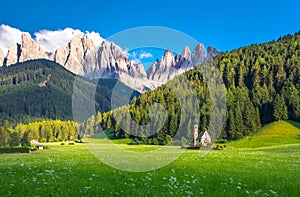 Traditional alpine St Johann church in Val di Funes valley, Santa Maddalena touristic village, Dolomites, Italy.