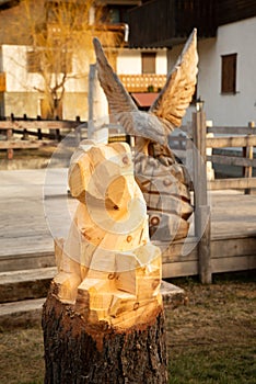 Traditional Alpine wooden art. Carving process, bear scuplture