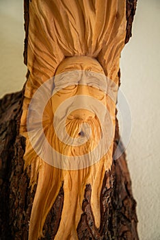 Traditional Alpine wooden art. Old man face scuplture