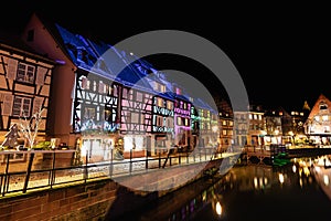 Traditional Alsatian half-timbered houses and river Lauch in Petite Venise or little Venice, old town of Colmar, decorated and