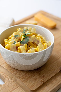 Traditional American macaroni and cheese comfort food also called mac n cheese with elbow pasta coated in a cheesy creamy cheddar
