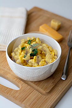 Traditional American macaroni and cheese comfort food also called mac n cheese with elbow pasta coated in a cheesy creamy cheddar