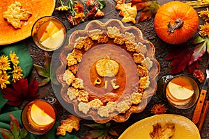 Traditional American Pumpkin Pie for Thanksgiving Day and Apple sangria. Top view, copy space. Concept thanksgiving table setting