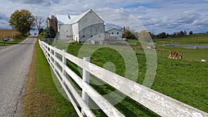 A traditional Amish barn and a white picket fence in the middle of Ohio, USA