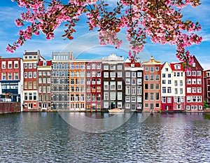 Traditional Amsterdam architecture on Damrak canal in spring, Netherlands
