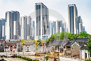 A traditional ancient village surrounded by modern architecture