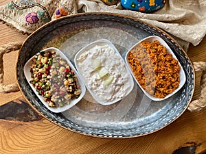Traditional Appetizer Bulgur or Bulghur Kisir, Celery Salad and Chickpea Lentil Salad. Turkish Greek Food in Copper Tray at Local