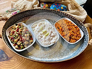 Traditional Appetizer Bulgur or Bulghur Kisir, Celery Salad and Chickpea Lentil Salad. Turkish Greek Food in Copper Tray at Local