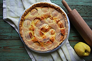Traditional apple pie, fruit dessert, tart with fresh apples on wooden rustic table. Top view