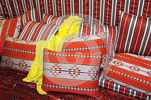 Traditional Arab yellow dress laying on a cushion