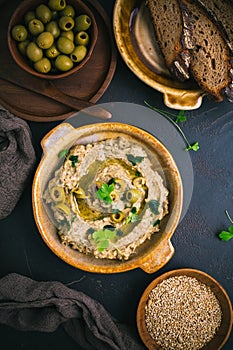 Traditional arabian eggplant dip (baba ganoush) on rustic dark table