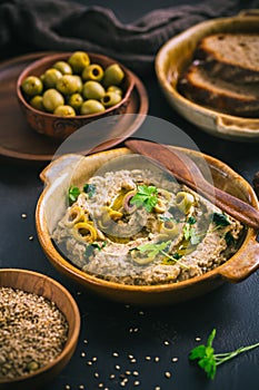 Traditional arabian eggplant dip (baba ganoush) on rustic dark table