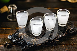 Traditional arabic alcohol drinks Raki with anise, rustic wooden background with space for text