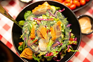 Traditional Arabic fattoush salad on plate. Middle eastern dish pita bread, vegetables, herbs, olive oil, and a dressing made with