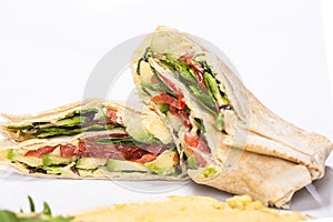 Traditional Arabic food `Shaorma` plate made out of tomatoes and salad roll in a pita