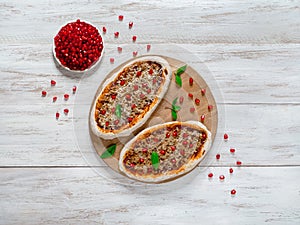 Traditional Arabic pizza manaqish with meat and pomegranate.