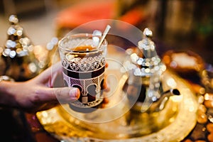 Traditional Arabic tea cup, arab people drinking tea in Ramadan