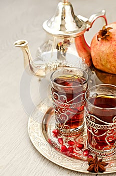 Traditional arabic tea with metal teapot and glasses vertical