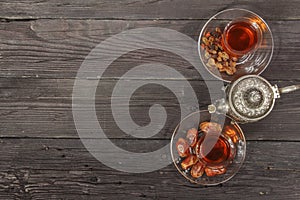 Traditional Arabic, Turkish Ramadan tea with dry dates and raisins on a wooden black table. Ramadan. Turkish fresh tea with dates.