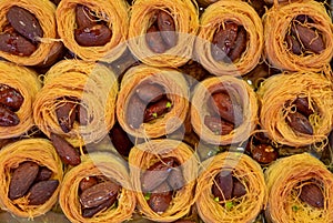 Traditional arabic and turkish sweets pastry dessert kadaif kunafa, baklava, with almonds