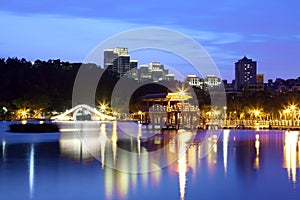 Traditional arch bridge and oriental pavilion by the lake