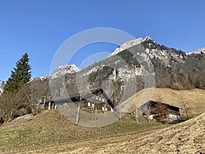 Traditional architecture and farmhouses in the alpine valley of KlÃ¶ntal or Kloental and by the resevoir lake KlÃ¶ntalersee