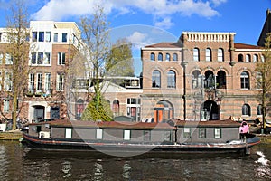 Traditional architecture and houseboat along canal, Amsterdam