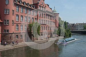 Traditional architecture and tourist boat on Rhine river at little France quarter in Strasbourg