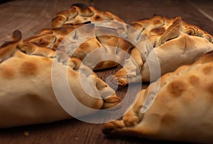 Traditional Argentinean empanadas pie on table, meat Chicken and vegetables