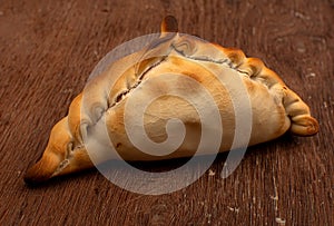 Traditional Argentinean empanadas pie on table, meat Chicken and vegetables