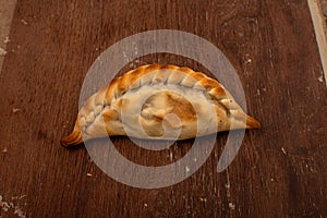 Traditional Argentinean empanadas pie on table, meat Chicken and vegetables