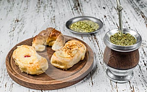 Traditional Argentinian yerba mate tea in calabash gourd and argentine pastries.
