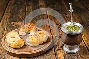 Traditional Argentinian yerba mate tea in calabash gourd and argentine pastries.