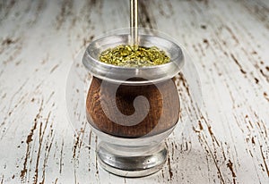 Traditional Argentinian yerba mate tea in a calabash gourd with bombilla stick.